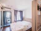 Bedroom with large bed, mirrored closet, and attached laundry room with washing machine