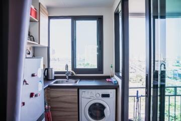 Modern kitchen with appliances and balcony access