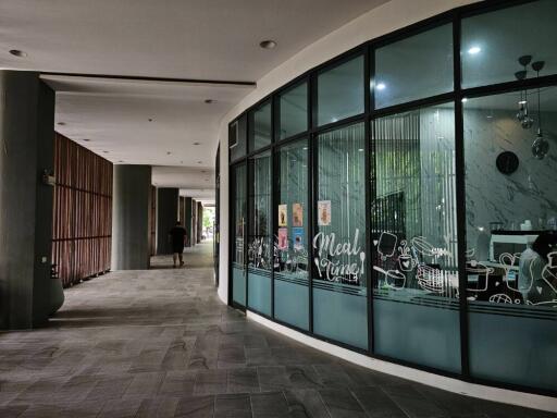 Corridor in front of a glass-walled restaurant