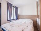 Cozy bedroom with large windows and a bed