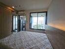 Bedroom with large window and balcony view