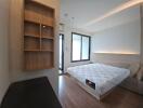 Modern bedroom with double bed and built-in shelves