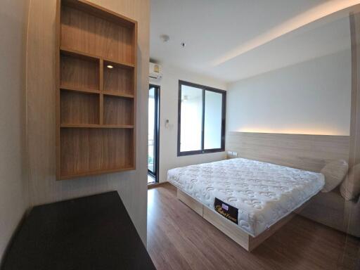 Modern bedroom with double bed and built-in shelves