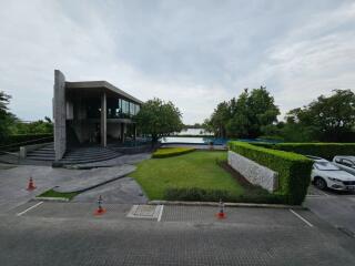 Modern building with green lawn and lake view