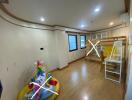 Well-lit bedroom with a loft bed, children's play area