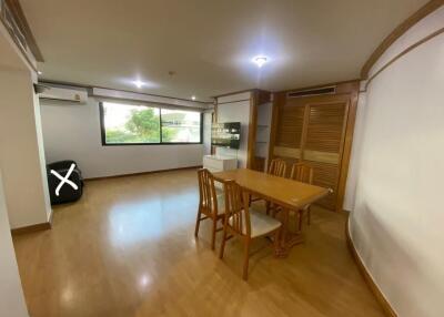 Dining room with wooden furniture and large window