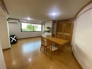 Dining room with wooden furniture and large window