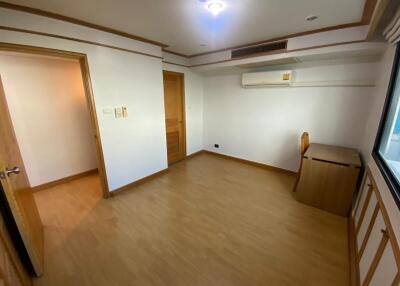 empty bedroom with wooden furniture and window