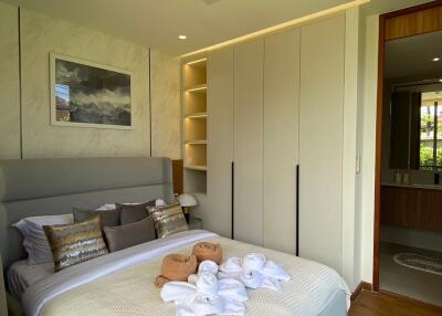 Modern bedroom with neatly arranged bed and built-in wardrobe