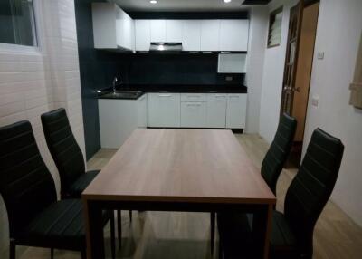 Modern kitchen and dining area with table and chairs