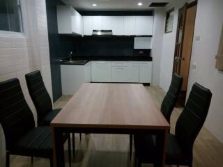 Modern kitchen and dining area with table and chairs