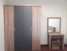 Bedroom with wardrobe and dresser with mirror