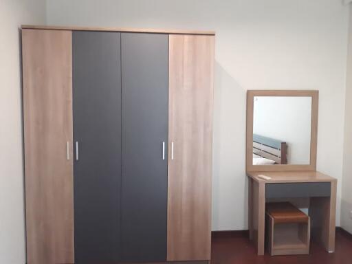 Bedroom with wardrobe and dresser with mirror