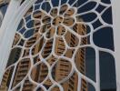 Ornate window with a reflection of a tall building