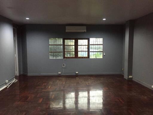 Spacious living room with hardwood flooring and large window