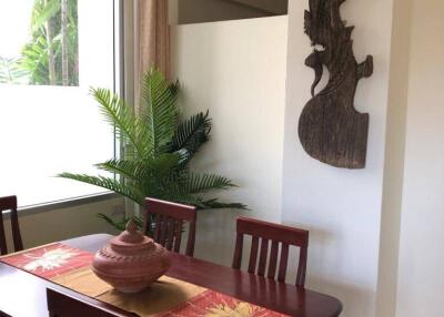 Dining area with wooden table and decorative wall art