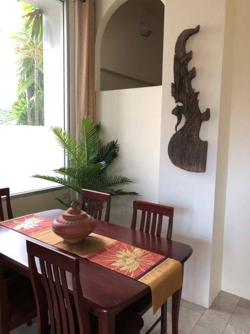 Dining area with wooden table and decorative wall art