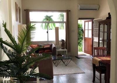 Spacious living room with large window and modern furnishings