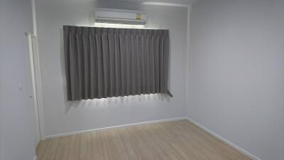 Bedroom with air conditioner and closed curtain