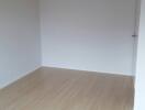 empty room with white walls and wooden floor