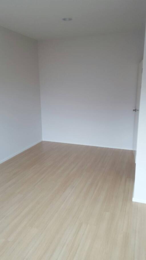 empty room with white walls and wooden floor