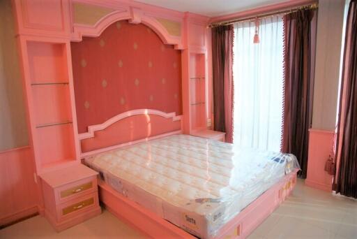 Bedroom with pink decor and large window