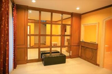 Living room with wooden paneling and bench