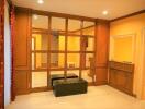 Living room with wooden paneling and bench