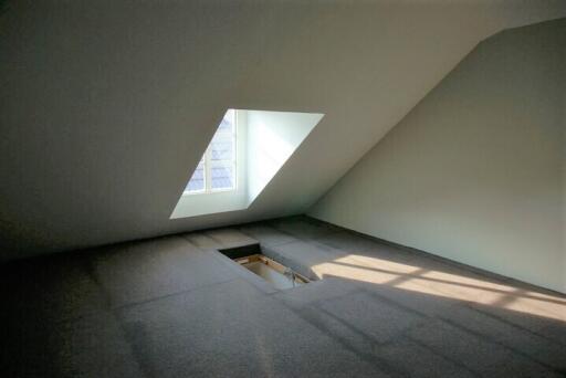 Empty attic space with window