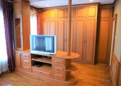 Living room with built-in entertainment unit and wardrobe cabinets