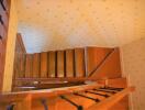 Staircase with wooden steps and patterned wallpaper