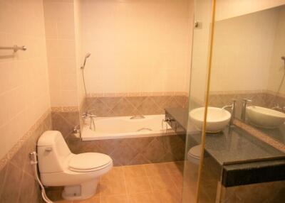 Bathroom with bathtub, toilet, sink, and mirror