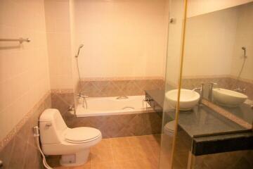 Bathroom with bathtub, toilet, sink, and mirror