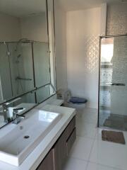 Modern bathroom with glass shower and large mirror