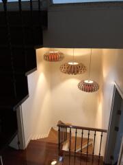 Staircase with hanging lights and wooden steps