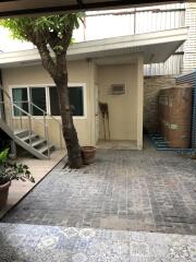 Outdoor area with stairs, tree, and storage tanks