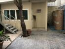 Outdoor area with stairs, tree, and storage tanks