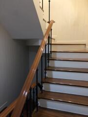 Interior staircase with wooden handrail