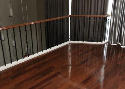 Spacious upstairs living area with wooden flooring and natural light