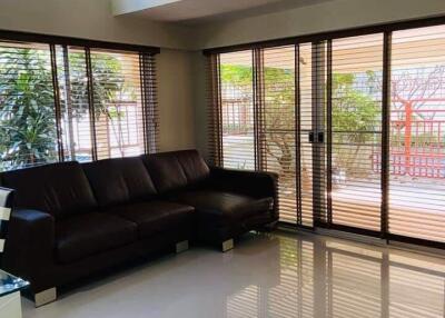 Modern living room with large windows and a sectional sofa