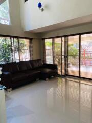 Modern living room with large windows and a sectional sofa