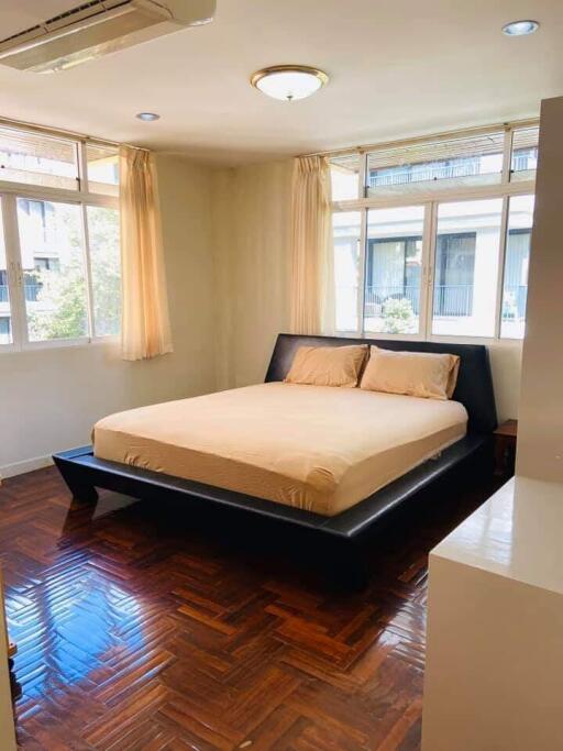 Spacious bedroom with large windows and a double bed