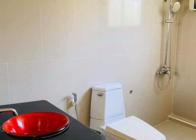 Modern bathroom with red sink and shower