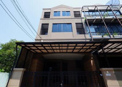 Modern multi-storey building exterior with gated entrance