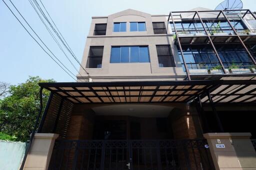 Modern multi-storey building exterior with gated entrance