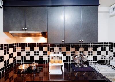 Modern kitchen with black and white tile backsplash