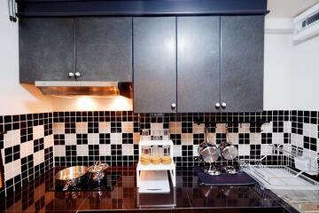 Modern kitchen with black and white tile backsplash