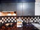 Modern kitchen with black and white tile backsplash