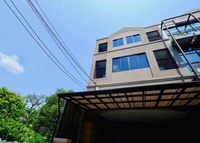 Front view of a multi-story residential building with large windows