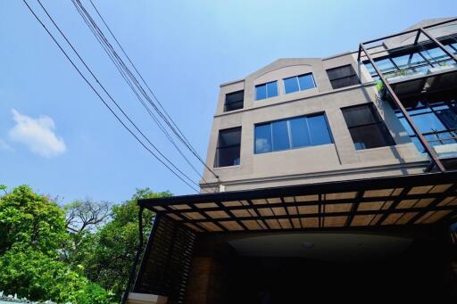 Front view of a multi-story residential building with large windows